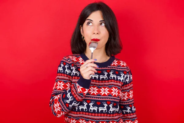 Very Hungry Brunette Caucasian Woman Wearing Christmas Sweater Red Background — Stock Photo, Image