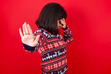 Güzel genç bir kadın, avuçlarıyla gözlerini kapatır ve herkesten saklanmaya çalışır..