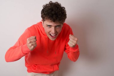 Genç bir adamın portresi kameraya heyecanla bakar, ellerini başının üstünde tutar, beklenmedik bir tepkiyi fark eder..