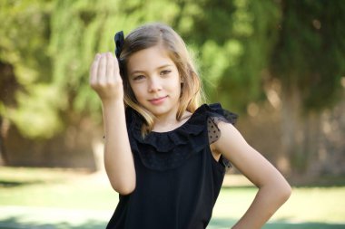 What the hell are you talking about. Shot of frustrated young European girl gesturing with raised hand doing Italian gesture, frowning, being displeased and confused with dumb question.