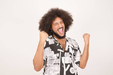 Beyaz kutlama başarısına izole edilmiş kıvırcık saçlı, etkileyici, genç ve etkileyici bir ırkın portresi.