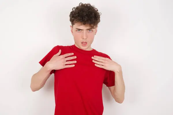 Handsome Young Man White Background Keeps Hands Chest Feeling Shocked — Stock Photo, Image