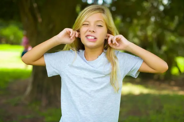 Happy Pretty Girl Ignores Loud Music Plugs Ears Fingers Asks — Stock Photo, Image