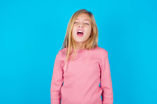 pretty girl yawns with opened mouth stands. Daily morning routine