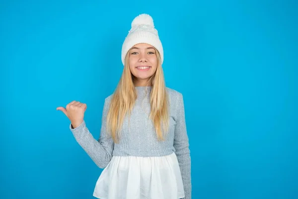 Piękne Piękne Dziecko Dziewczyna Białej Dzianiny Kapelusz Niebieski Sweter Wskazując — Zdjęcie stockowe