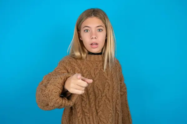 Shocked Blonde Kid Girl Wearing Brown Knitted Sweater Blue Background — Stock Photo, Image