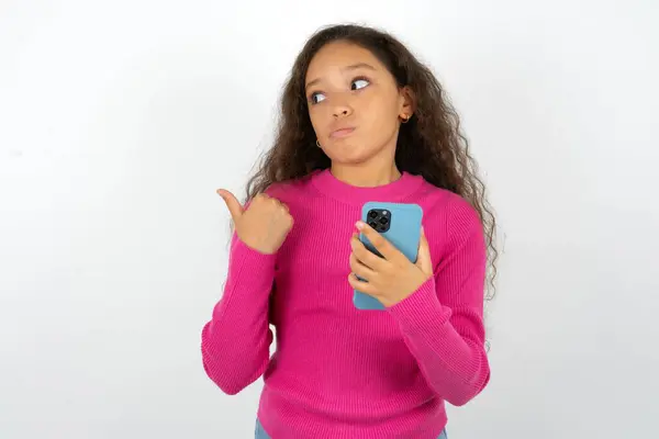 Teenager Girl Wearing Pink Sweater Points Thumb Away Shows Blank — Stock Photo, Image