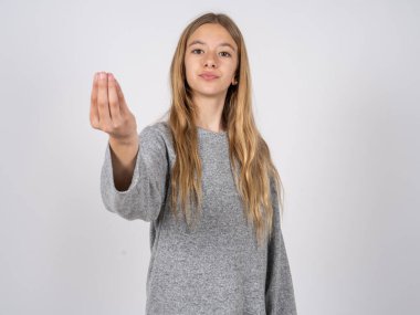 Gri eşofman giyen güzel beyaz kız İtalyanca jest yapıyor.