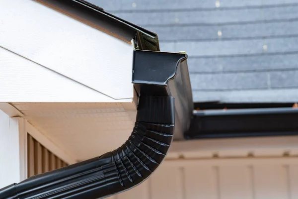 stock image gutter with downpipe on the roof of a house rooftop