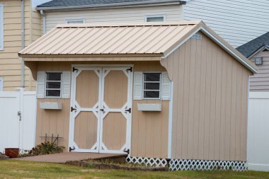 the shed is used as outdoor storage and commonly located in home backyard double doors nature new roof