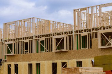 new condominium or apartment construction plywood frame wood modern new wooden window facade
