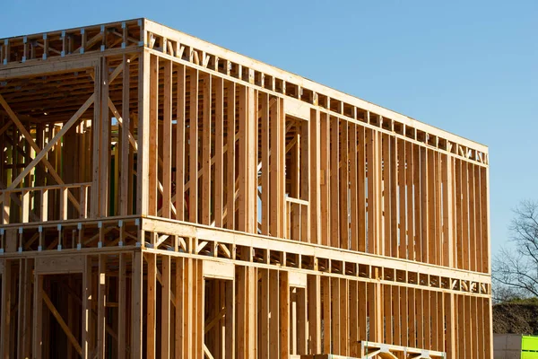 new residential construction home framing against a blue sky wooden construction plywood beam plank wall