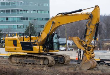 a large construction excavator of yellow color on the construction site in a quarry for quarrying work shovel soil big