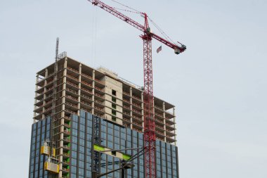 large crane and construction of building city high tower
