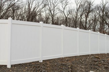 white vinyl fence in residential neighborhood modern home private