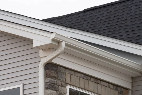 stock image gutter with downpipe on the roof of a house metal pipe wall rain