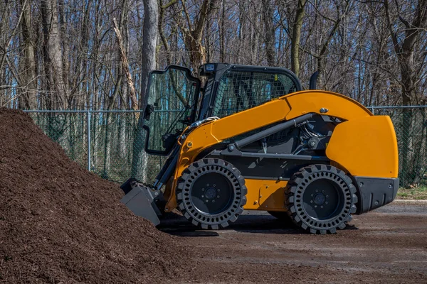 Stock image compact track loader mulch bio woods raw tractor