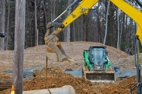 excavator digging a deep trench loader scoop mover dirt