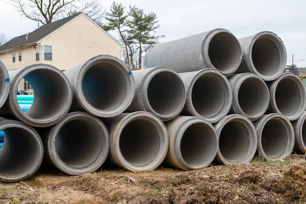 reinforced concrete storm sewer pipes stacked at a construction site large diameter pipes stack closeup