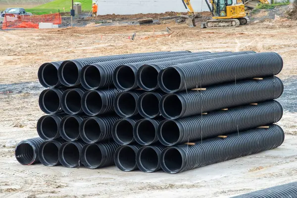 group of big corrugated pipes made of black plastic pipeline water