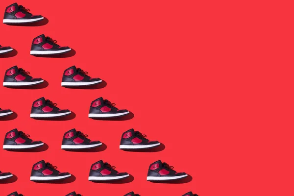 stock image Pattern of NIKE Jordan Access sneakers in black and red, on the left side, on a red background. Concept of sneaker, basketball, retro, michael jordan, fashion, collection and casual