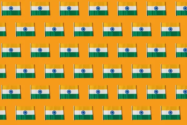 Pattern of flags of the Republic of India on orange background. Concept of Republic Day of India, January 26, Independence Day, August 15, celebration, orange, green, white and patriotism.