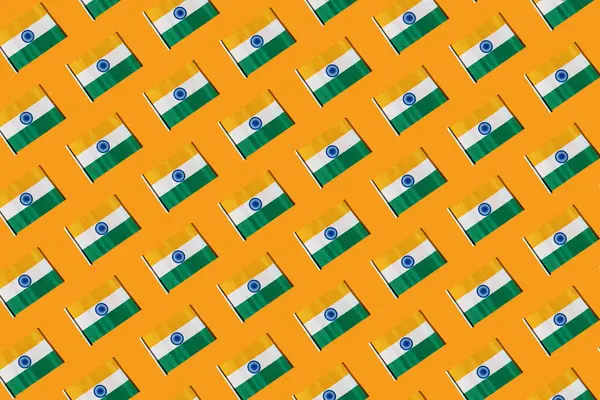 Pattern of flags of the Republic of India on orange background. Concept of Republic Day of India, January 26, Independence Day, August 15, celebration, orange, green, white and patriotism.