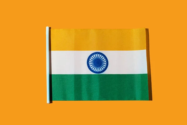 Flag of the Republic of India on orange background. Concept of Republic Day of India, January 26, Independence Day, August 15, celebration, orange, green, white and patriotism.
