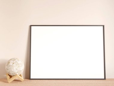 Modern and minimalist horizontal black poster or photo frame mockup on the living room wooden table. 3d rendering.