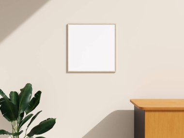 Minimalist iç odasının duvarında bitkilerle birlikte çerçeve modeli asılı.