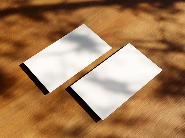 Clean minimal business card mockup with the leaves shadow on wood table background