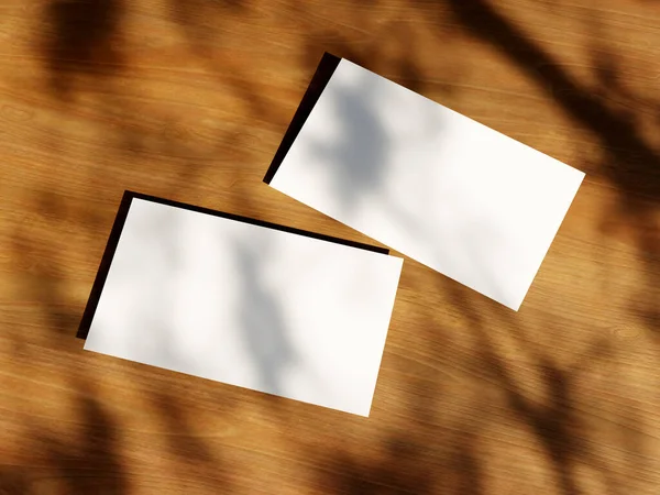 Clean minimal business card mockup with the leaves shadow on wood table background