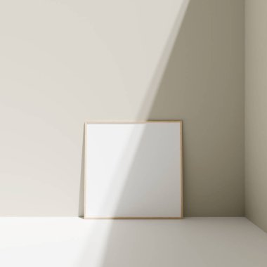 Poster fotoğraf çerçevesi gölgeli zemindeki pastel duvara yaslanmış.