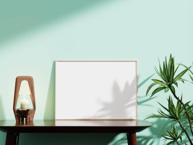 Nane yeşili bir duvarda şık beyaz bir çerçeve, ahşap bir mum tutacağı ve canlı bir yeşillik, sanatsal düzenlemeler için ideal..