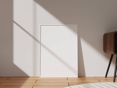 A sleek white photo frame leaning against a wall, illuminated by natural light, ideal for modern decor and art presentations.