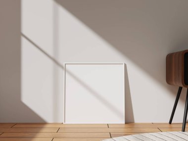 A white frame with a sleek design leaning against a wall, illuminated by sunlight, ideal for showcasing photographs or artwork in a bright setting.