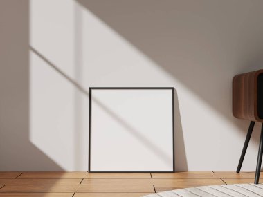 A modern black frame set against a light wall, capturing shadows and natural light, perfect for art displays or stylish decor.