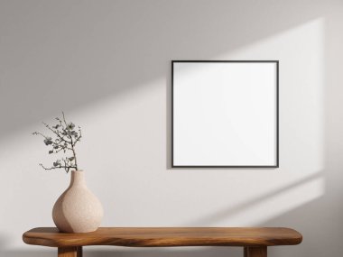 Stylish square poster frame mockup in black, designed for an elegant display alongside a vase on a wooden table.