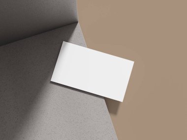 Gri çimento blokta, yumuşak ışıklandırmalı bir kartvizit modeli, profesyonel bir tasarım için zarif bir zemin oluşturuyor..