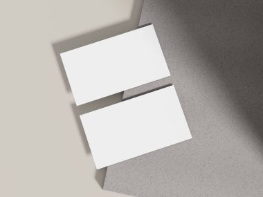 Gri çimento bloğun üzerinde modern markalaşma sunumları için mükemmel ışıklandırmalı bir kartvizit modeli..