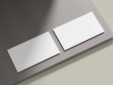 Açık gri çimento bloğun üzerine kurulmuş bir kartvizit modeli. Temiz hatları var. Kurumsal kimliği gözler önüne sermek için uygun..