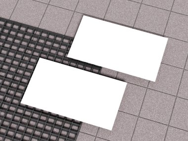 Izgara desenli beton zemin üzerinde iki kartvizit..