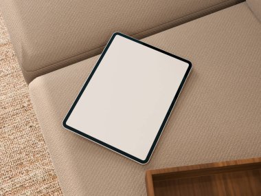 Tablet rahat bir koltukta dinleniyor, ev ya da yaşam tarzı sunumları için ideal..