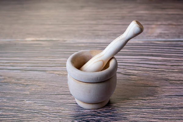 wooden mortar and pestle isolated on wooden