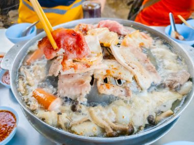 Tahta çubuklarda ızgara domuz eti, sıcak tavada Tayland bbq Barbeküsü, sıcak sobada ızgara domuz eti ve restoranda yemek.