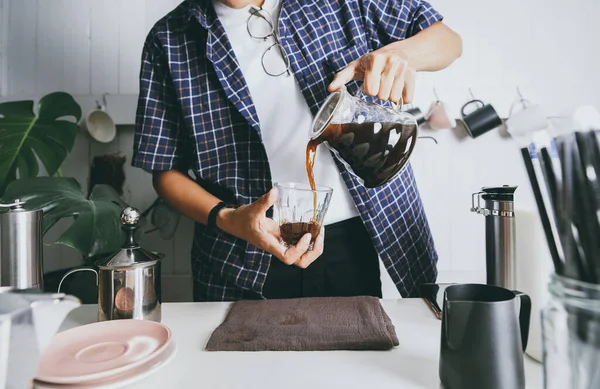 Close up Man using italian classic Moka coffee pot pouring, coffee make with equipment tool brewing table. 