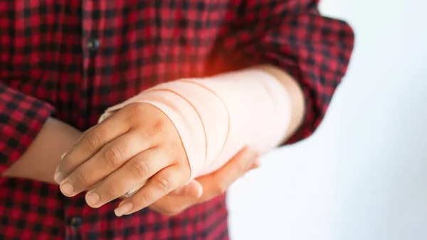 Boy in a splint, medical treatment, bone wrist rehabilitation due to falls, fractures, accidents, person. Soft focus and selective copy space for text