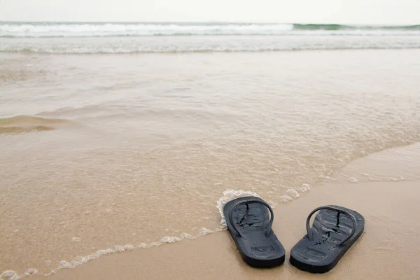 Cierra Los Pies Las Zapatillas Negras Playa Con Una Ola — Foto de Stock
