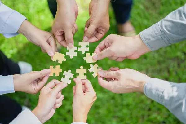  partnership, fitting together the pieces of environmental, social, and governance (ESG) strategies for sustainable success, symbolized by a jigsaw puzzle in hand.	