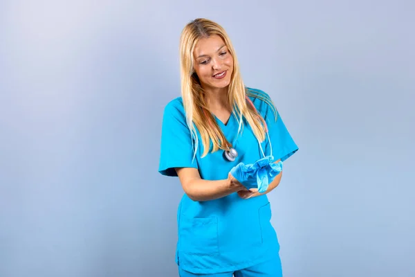 Junge Blonde Krankenschwester Zieht Handschuhe — Stockfoto